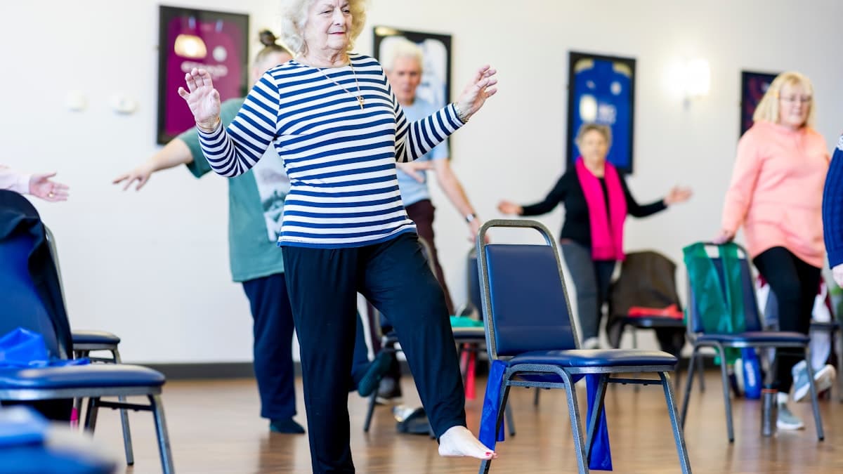 Adults practicing balance work in a fitness class