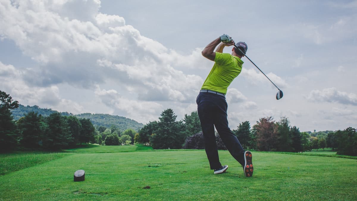 A golfer following through on a swing