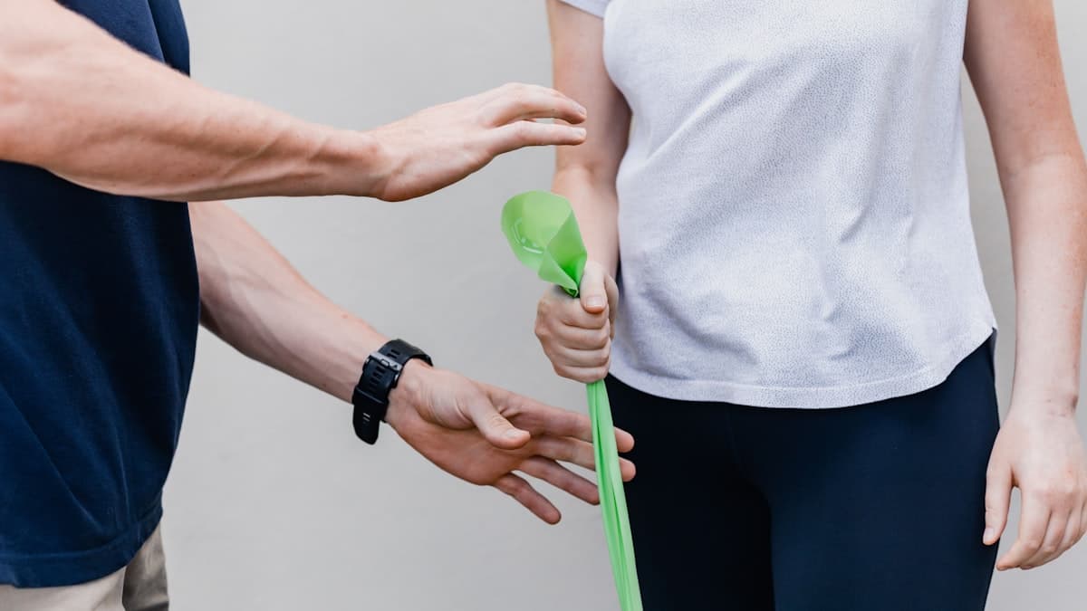 A therapist guiding a resistance-band recovery exercise