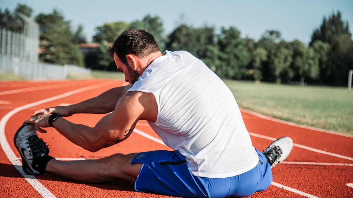 An older adult stretching to ease joint stiffness